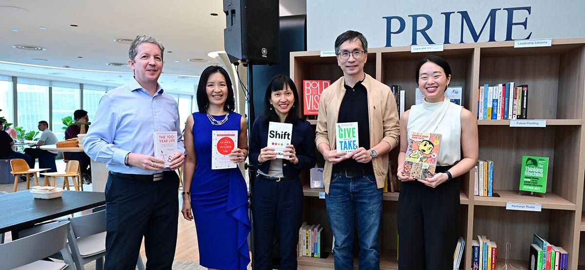 GICians with their favourite books at the pop-up library in our Singapore office.
